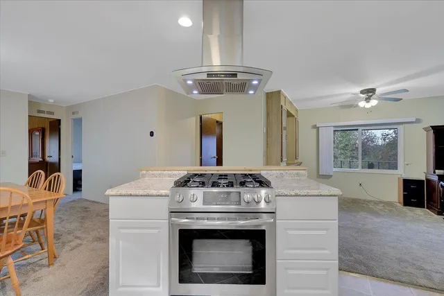 a kitchen with stainless steel appliances granite countertop a stove and a sink