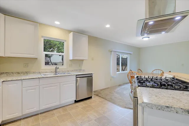 a kitchen with stainless steel appliances granite countertop a sink and cabinets