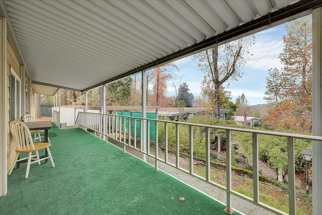 a view of a chair and table in the deck