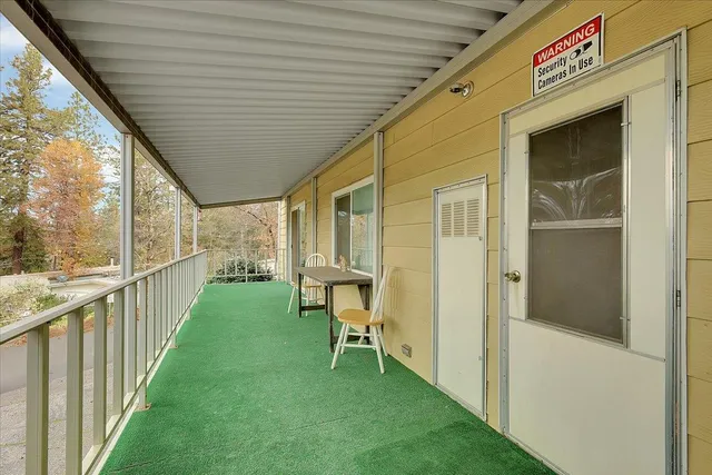 a porch with a table and chairs