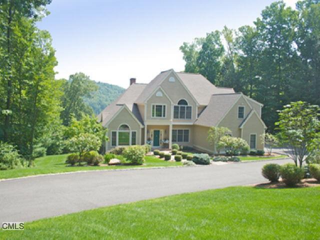 24 Lake Road Newtown, CT 06470 - Photo 1 of 1 a front view of a house with a garden and plants
