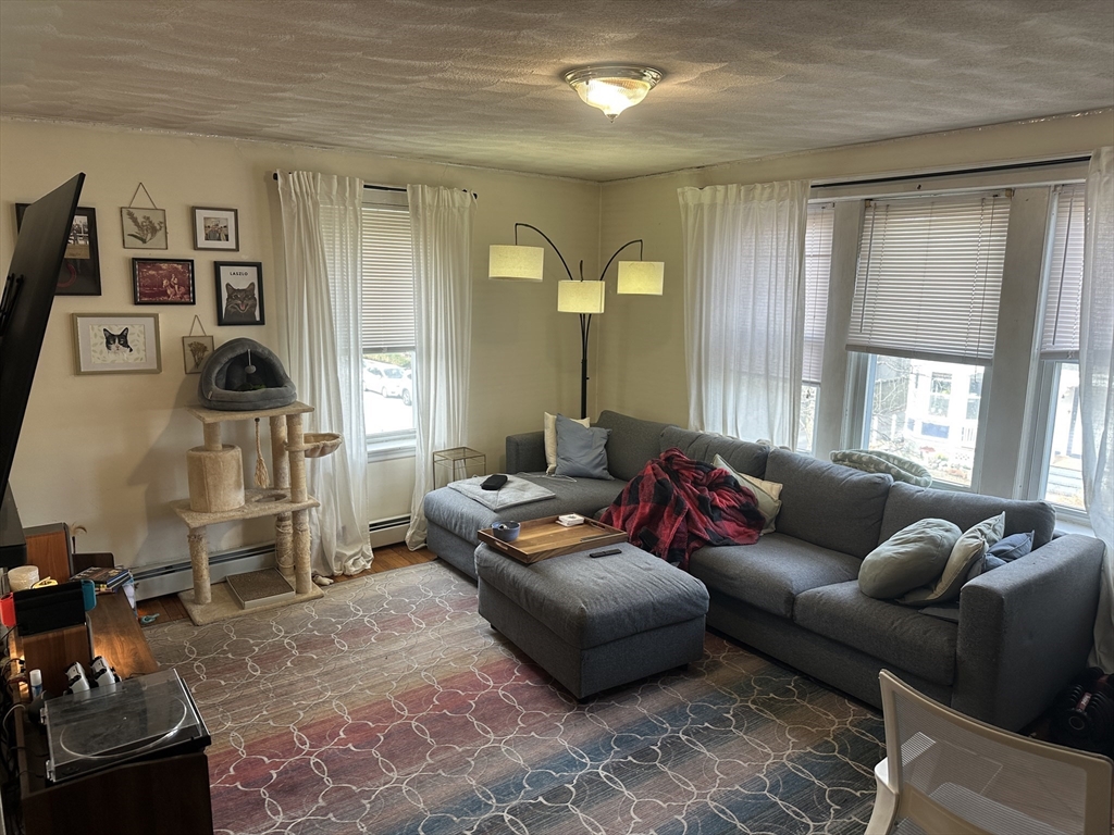 38 Day Street, Unit 20 Somerville, MA 02144 - Photo 2 of 9 a living room with furniture and a flat screen tv