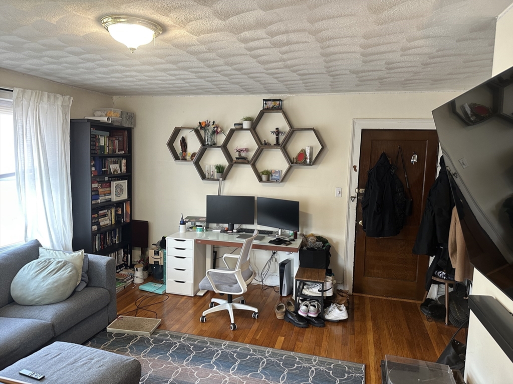 38 Day Street, Unit 20 Somerville, MA 02144 - Photo 3 of 9 a work room with furniture a air conditioner vent and a window