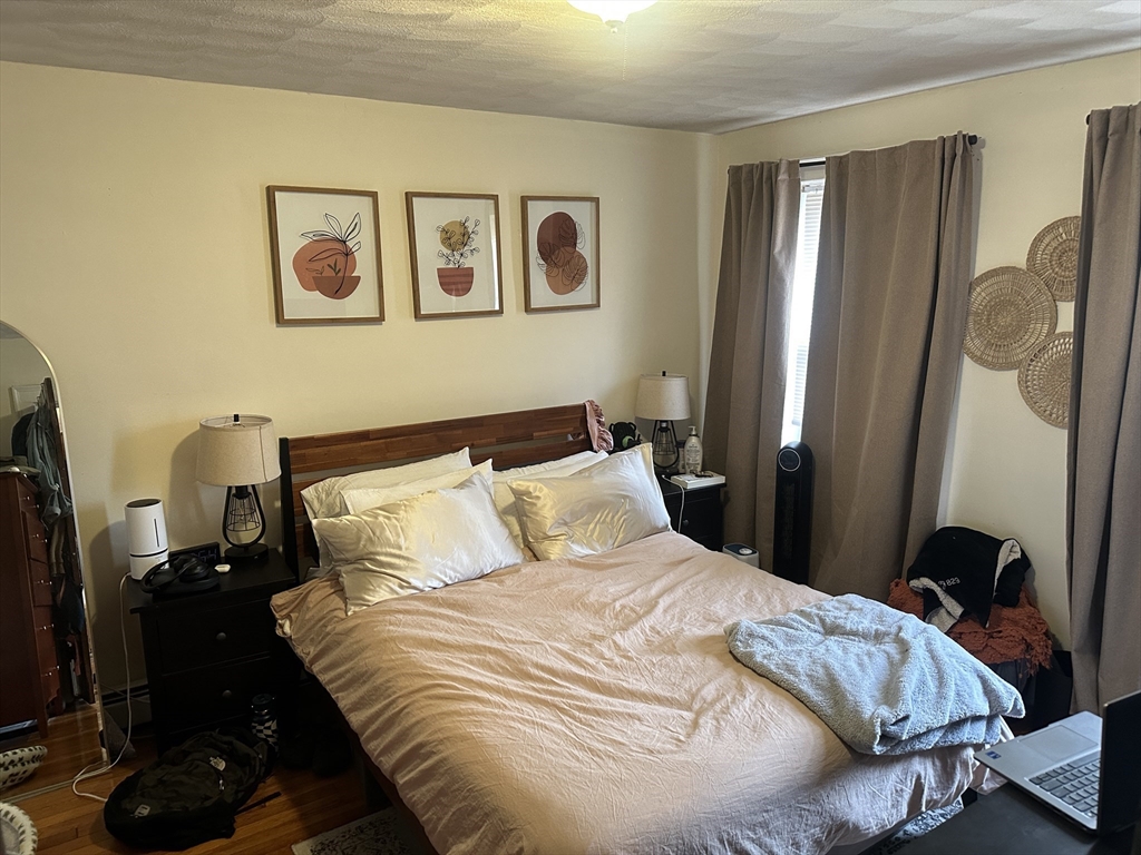 38 Day Street, Unit 20 Somerville, MA 02144 - Photo 4 of 9 a bedroom with a bed and a window