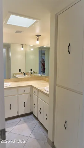 a bathroom with a double vanity sink a toilet and a mirror