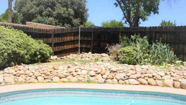 a view of a backyard with sitting area