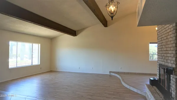 a view of a livingroom with wooden floor and window