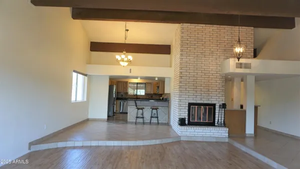an entryway with fireplace and wooden floor