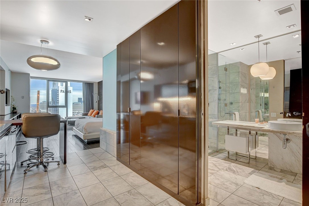 4381 West Flamingo Road, Unit 2204 Las Vegas, NV 89103 - Photo 17 of 27 Ensuite bathroom with expansive windows and marble finish floors