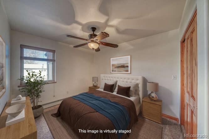 138 North M Street, Unit C Salida, CO 81201 - Photo 18 of 47 a bedroom with a bed and a chandelier