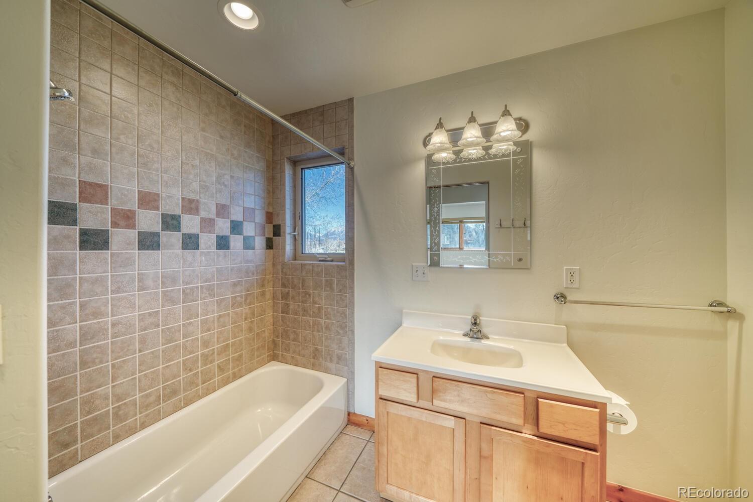 138 North M Street, Unit C Salida, CO 81201 - Photo 27 of 47 a bathroom with a sink mirror and a bathtub
