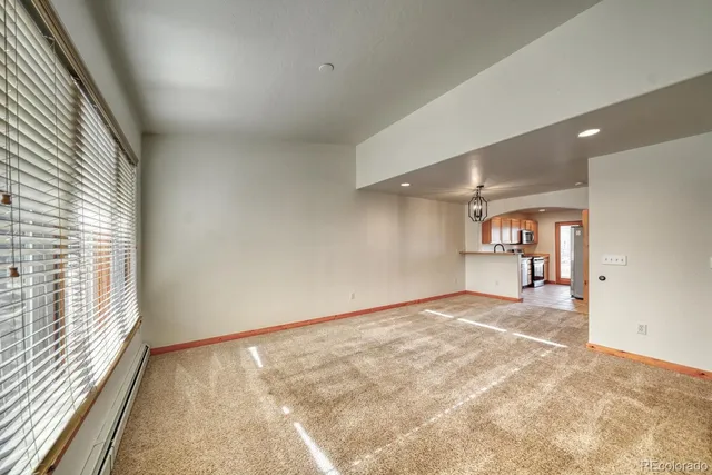 an empty room with a empty space and windows