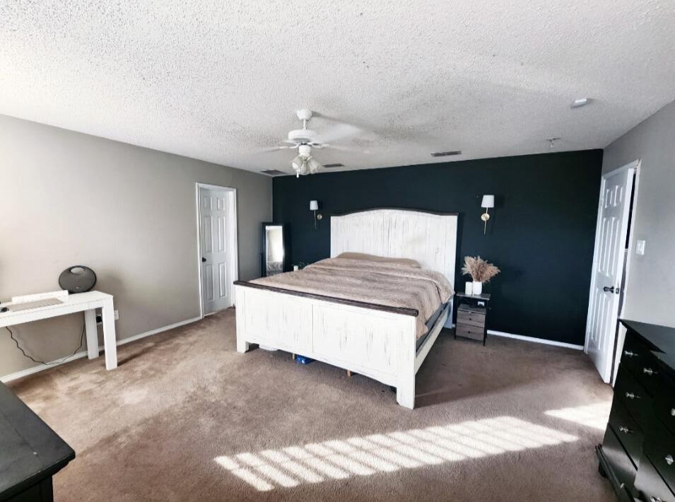 6821 84th Street Lubbock, TX 79424 - Photo 5 of 14 a spacious bedroom with a bed and a view of kitchen