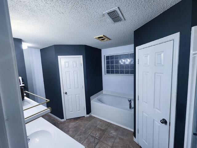 6821 84th Street Lubbock, TX 79424 - Photo 7 of 14 a bathroom with a tub shower and sink