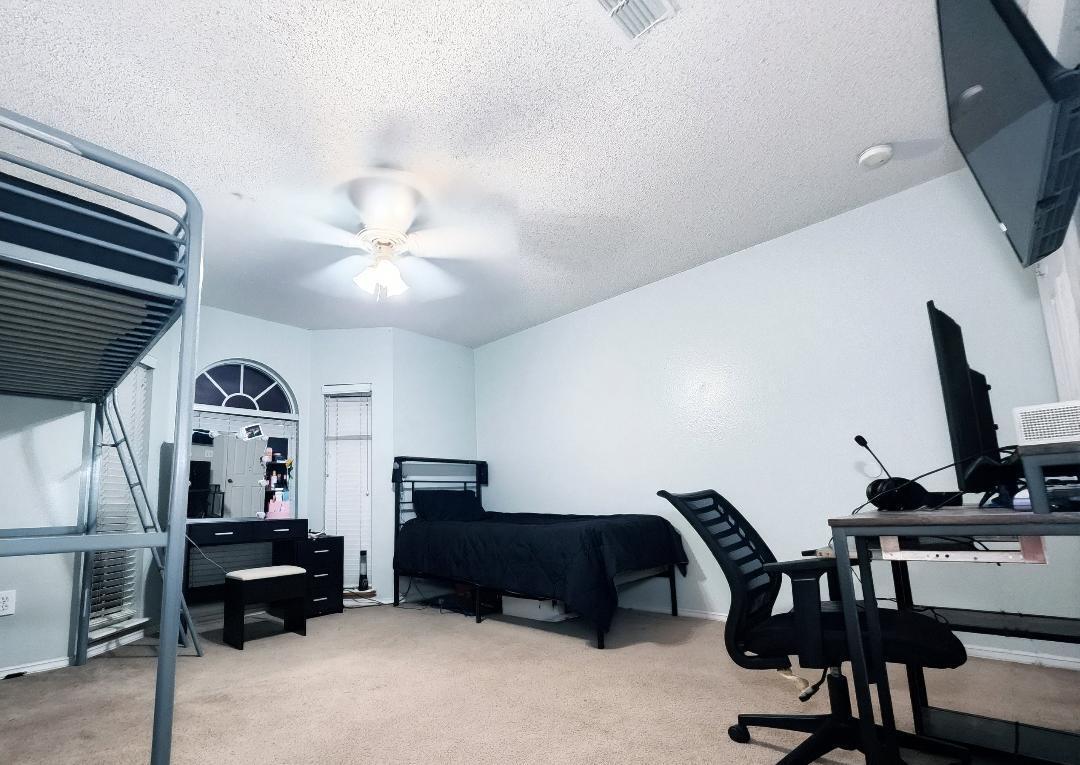 6821 84th Street Lubbock, TX 79424 - Photo 10 of 14 a living room with furniture and a flat screen tv