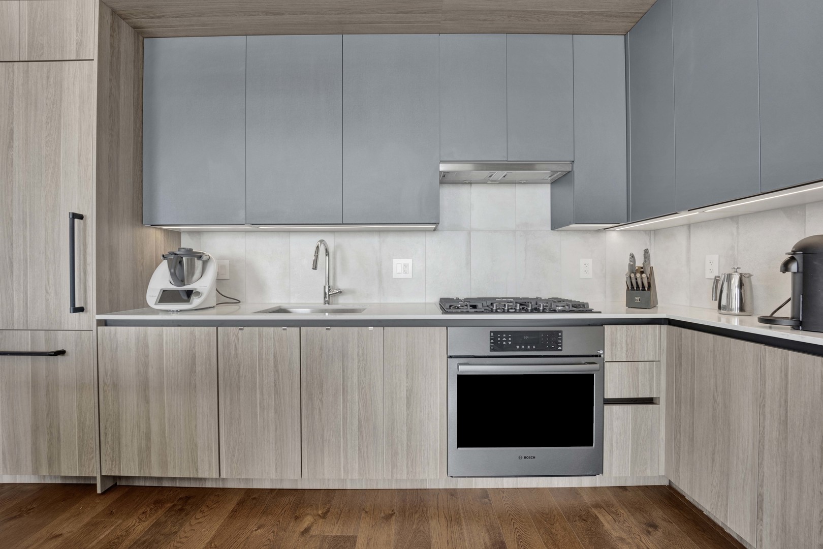 234 West Polk Street, Unit 2903 Chicago, IL 60607 - Photo 11 of 39 a kitchen with granite countertop wood cabinets and stainless steel appliances