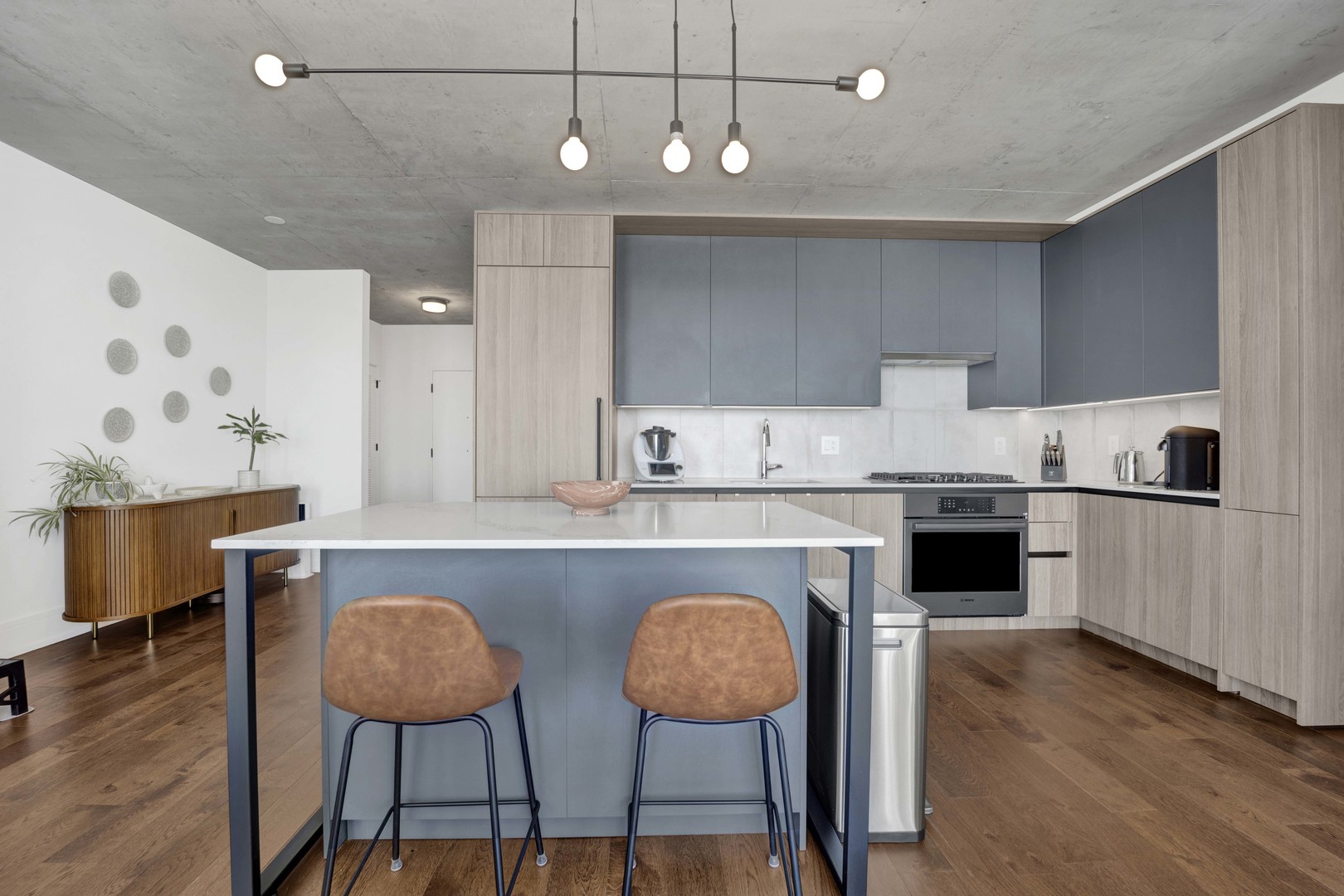 234 West Polk Street, Unit 2903 Chicago, IL 60607 - Photo 12 of 39 a kitchen with stainless steel appliances granite countertop a sink counter space chairs and wooden floor