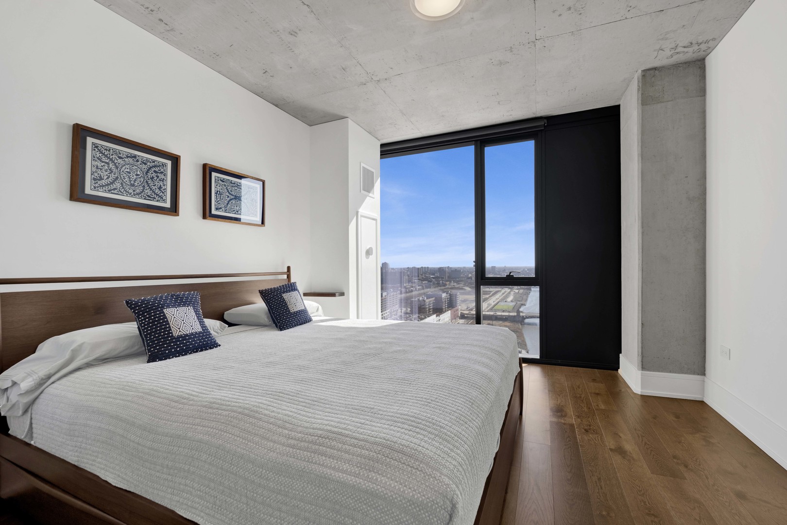 234 West Polk Street, Unit 2903 Chicago, IL 60607 - Photo 14 of 39 a bedroom with a large bed and a large window