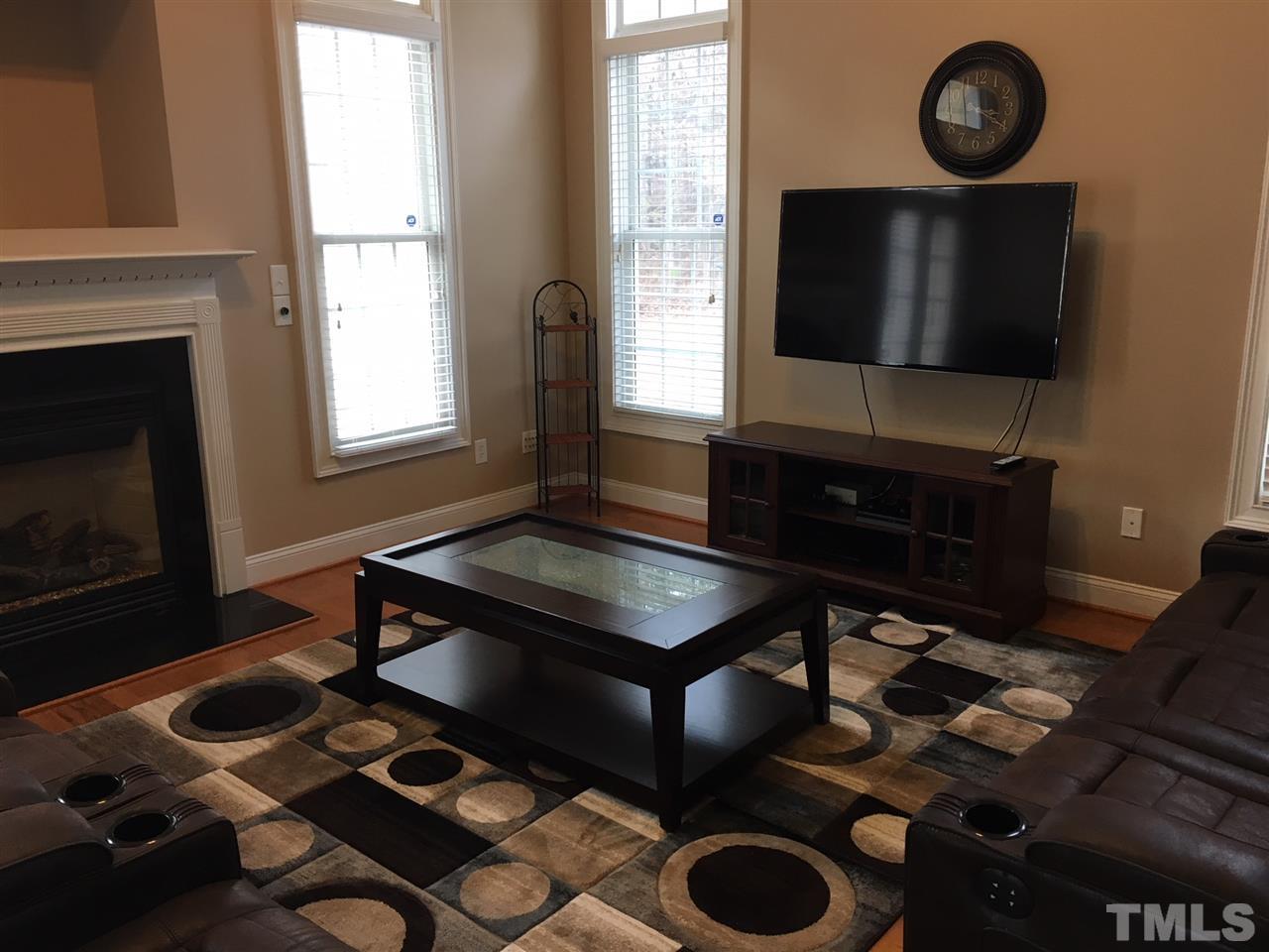 105 Fort Jackson Road Morrisville, NC 27560 - Photo 13 of 18 a living room with furniture a rug and a flat screen tv