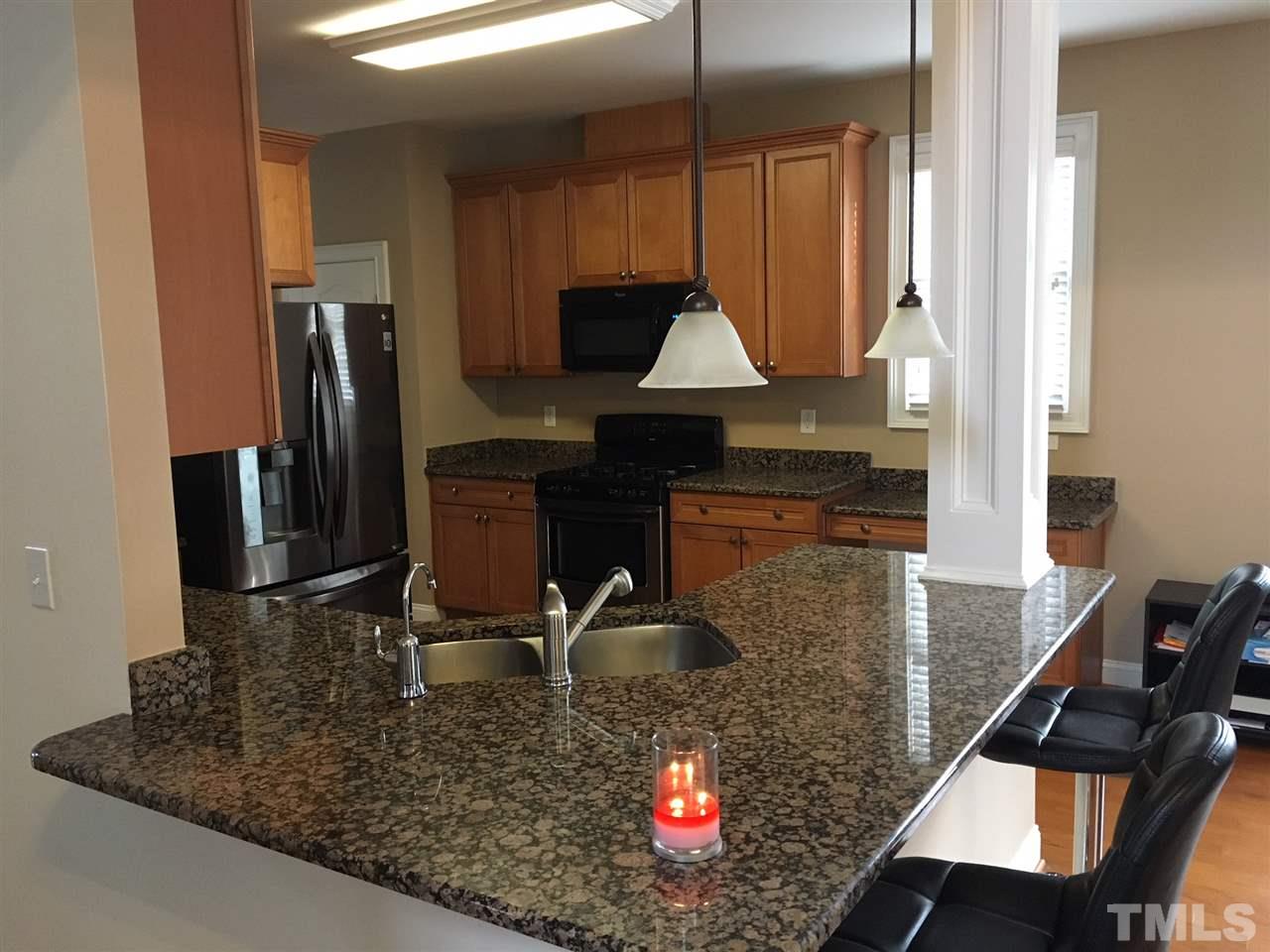 105 Fort Jackson Road Morrisville, NC 27560 - Photo 4 of 18 a kitchen with kitchen island granite countertop a stove a sink and a refrigerator