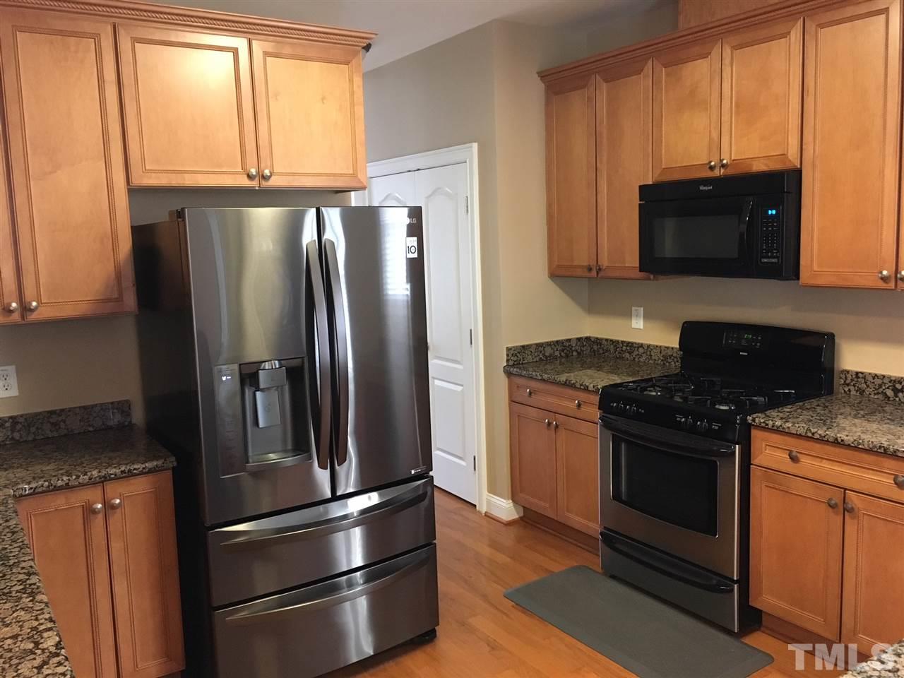 105 Fort Jackson Road Morrisville, NC 27560 - Photo 5 of 18 a kitchen with granite countertop a refrigerator stove and microwave