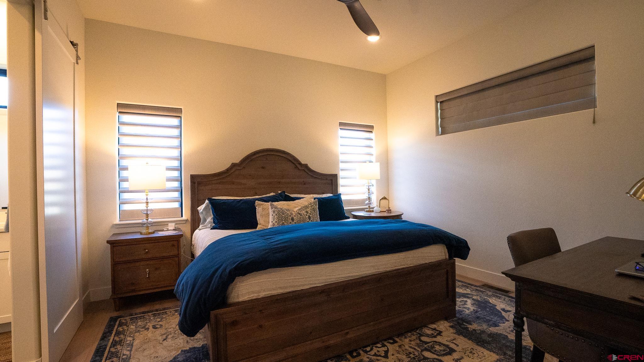 236 Via Tuscana Durango, CO 81301 - Photo 13 of 31 a bedroom with a bed and a window