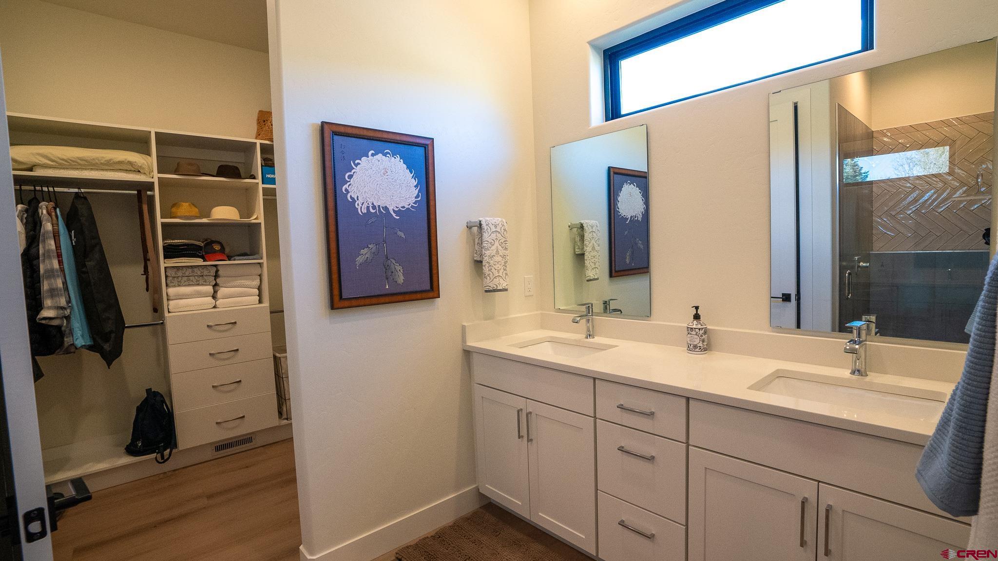 236 Via Tuscana Durango, CO 81301 - Photo 17 of 31 a bathroom with a double vanity sink and mirror