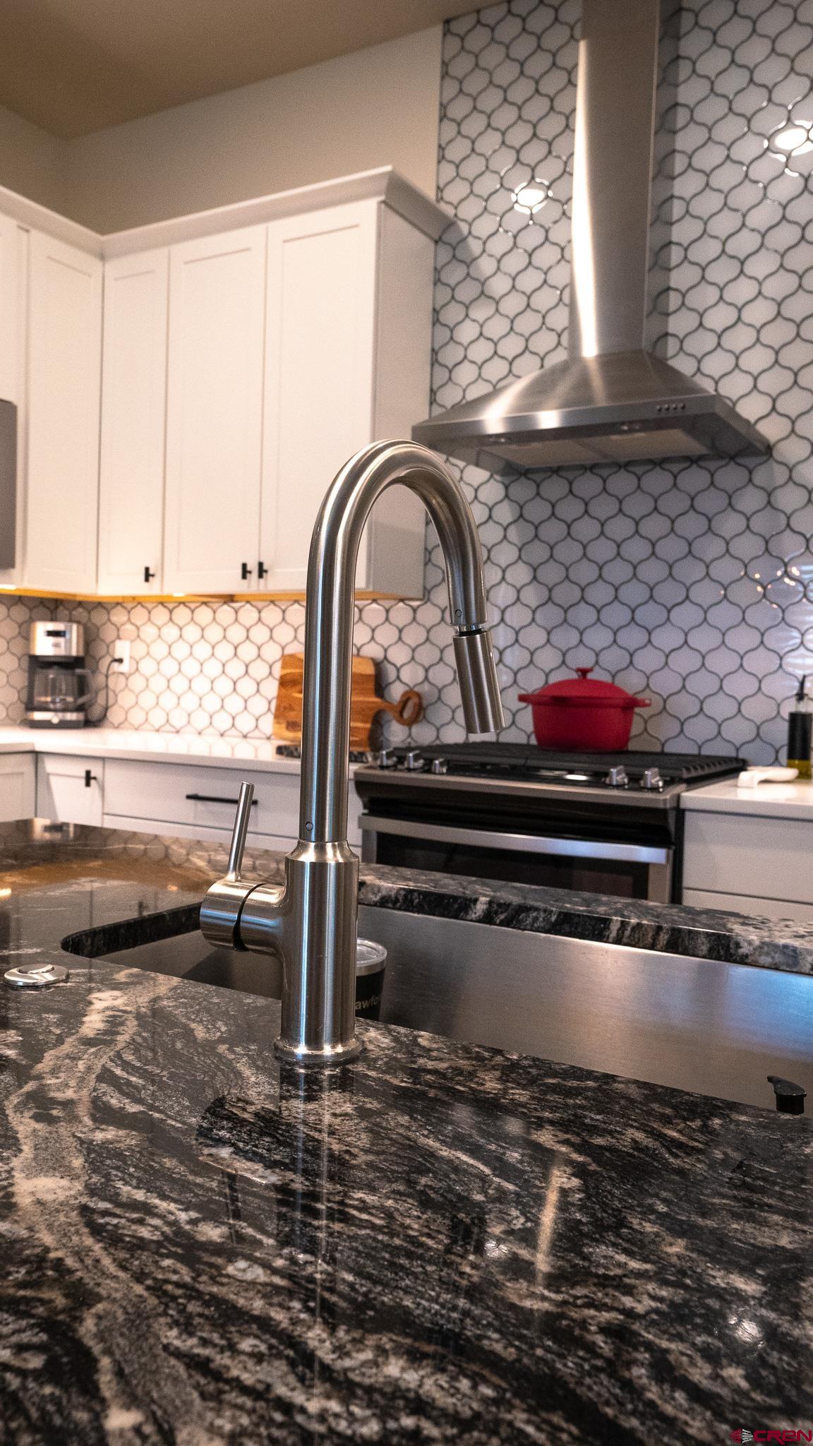 236 Via Tuscana Durango, CO 81301 - Photo 9 of 31 a close view of a sink a stove and wooden floor