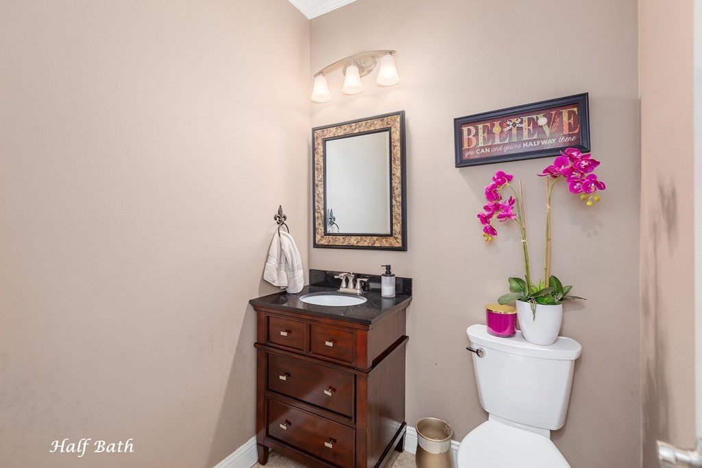 1171 Old Ewing Road Lufkin, TX 75901 - Photo 28 of 49 a bathroom with a toilet a sink and a mirror
