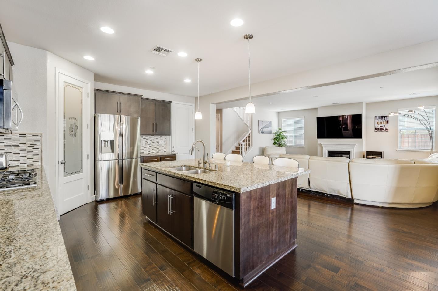333 Calle Cerro Morgan Hill, CA 95037 - Photo 11 of 45 a kitchen with stainless steel appliances granite countertop a lot of counter space and wooden floor