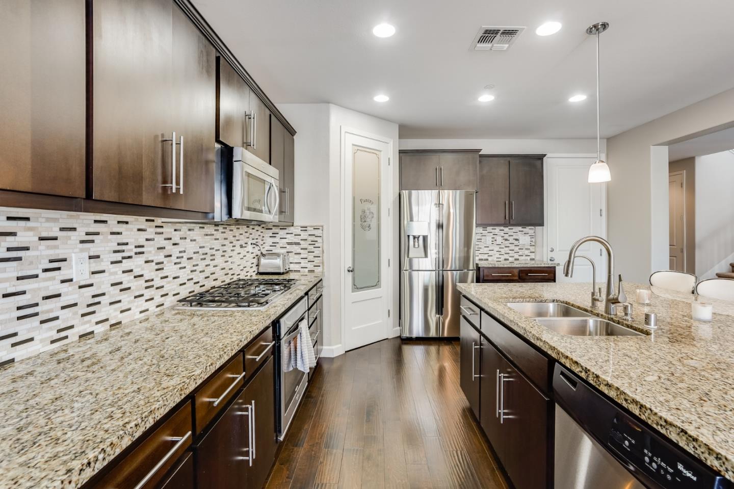333 Calle Cerro Morgan Hill, CA 95037 - Photo 13 of 45 a kitchen with stainless steel appliances granite countertop a sink stove and refrigerator