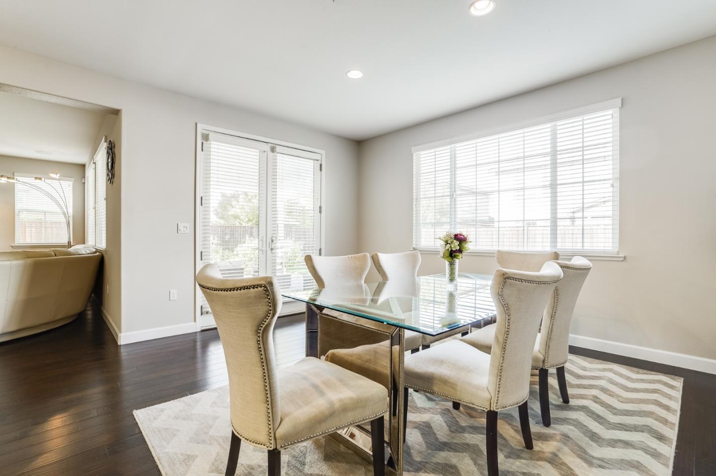 333 Calle Cerro Morgan Hill, CA 95037 - Photo 16 of 45 a view of a dining room with furniture wooden floor and a potted plant