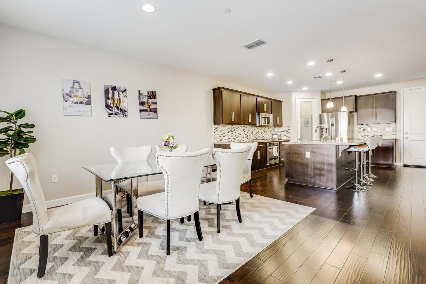 333 Calle Cerro Morgan Hill, CA 95037 - Photo 17 of 45 a view of a dining room with furniture a rug and wooden floor