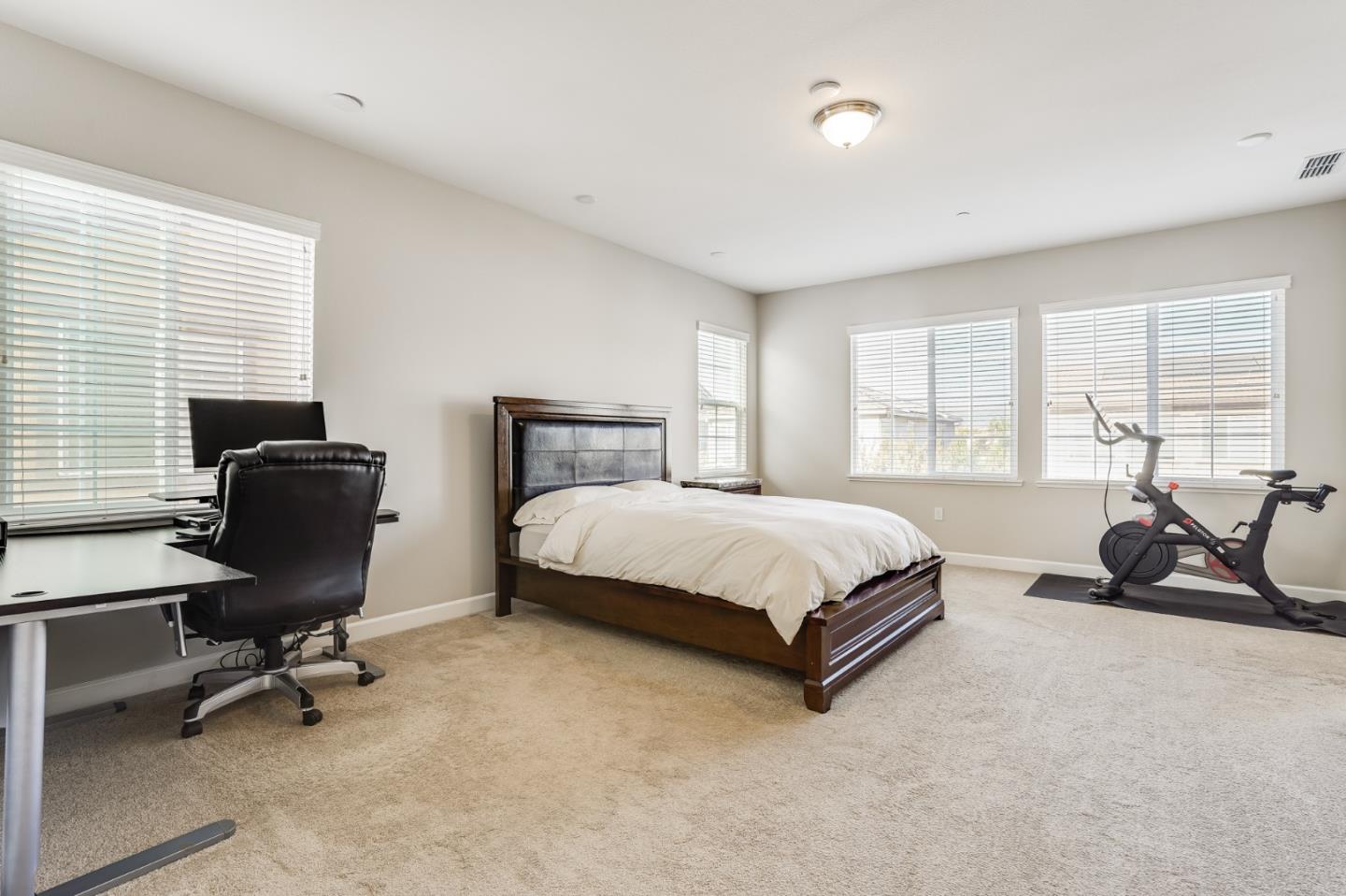 333 Calle Cerro Morgan Hill, CA 95037 - Photo 22 of 45 a bedroom with a bed a desk chair and a window