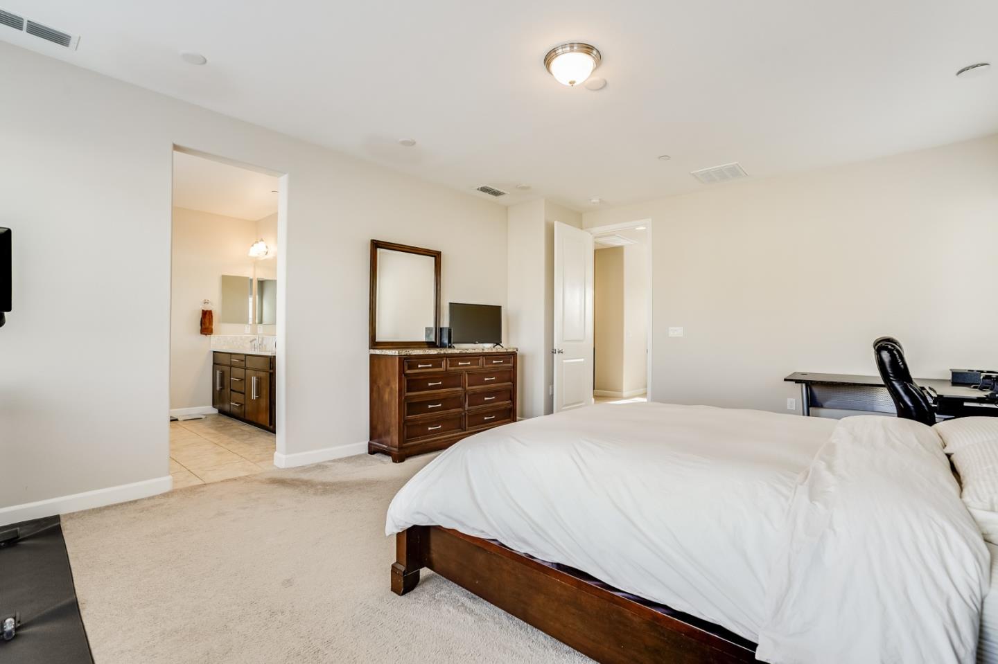 333 Calle Cerro Morgan Hill, CA 95037 - Photo 24 of 45 a spacious bedroom with a bed and a television