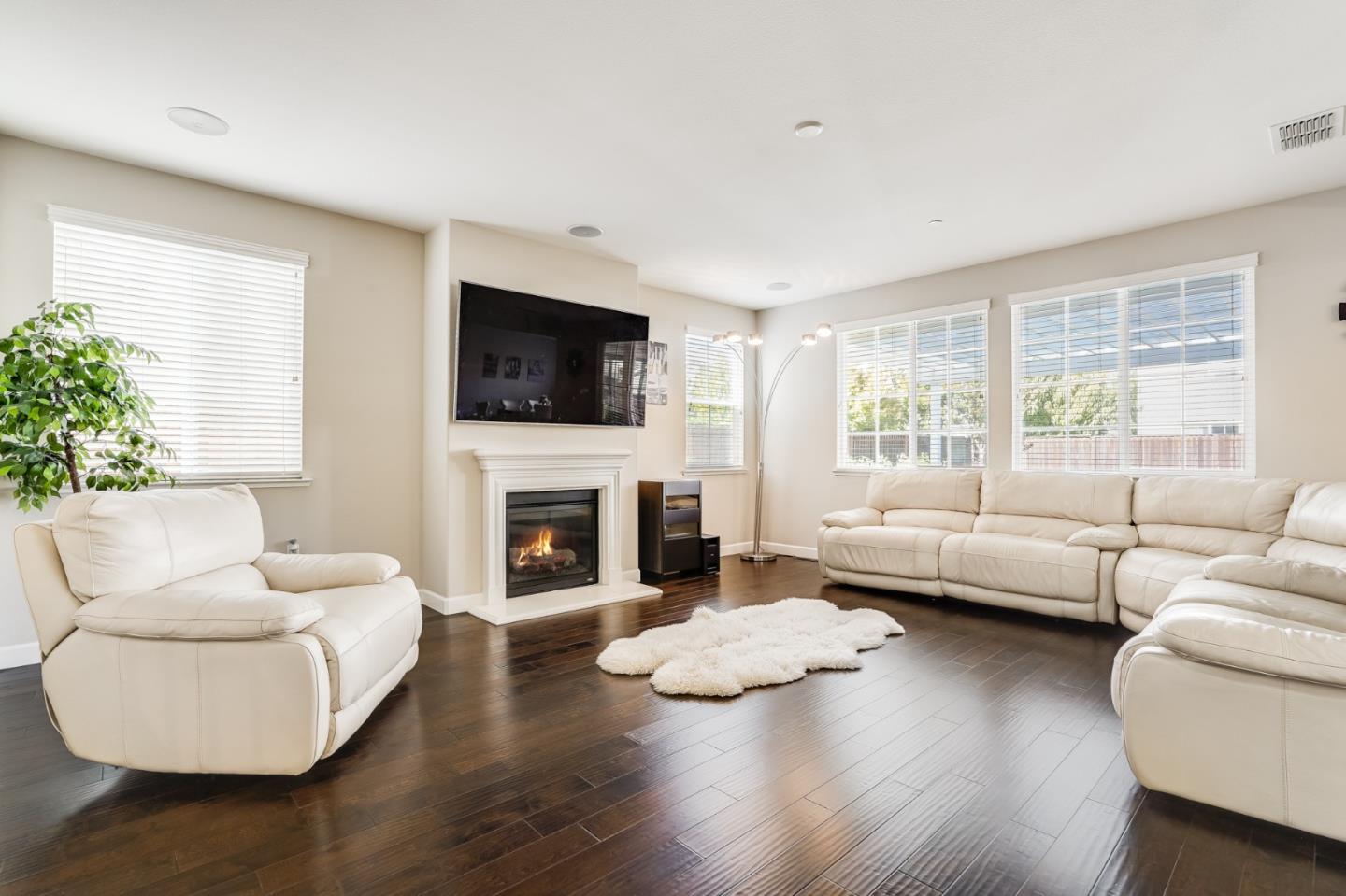333 Calle Cerro Morgan Hill, CA 95037 - Photo 6 of 45 a living room with furniture a fireplace and a flat screen tv