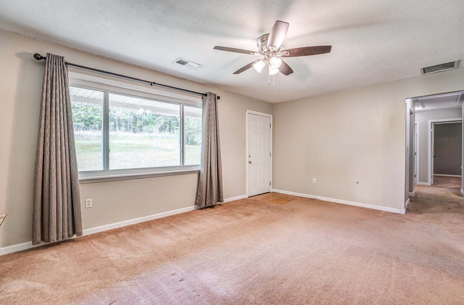 6125 Warren Road Oakland, TN 38060 - Photo 9 of 40 Living space with neutral-toned carpet and light gray walls
