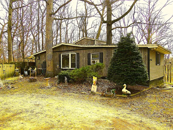a backyard of a house with table and chairs under an umbrella