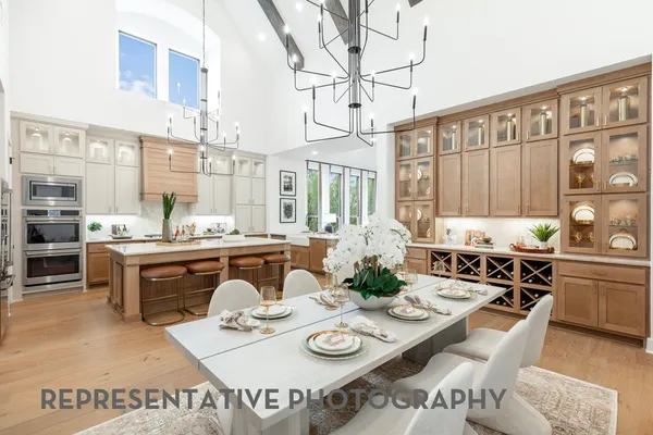 a kitchen with stainless steel appliances granite countertop a stove and white cabinets