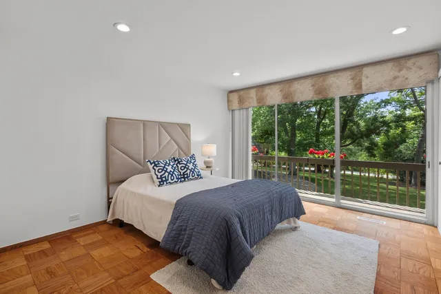 a bedroom with a large bed and a large window