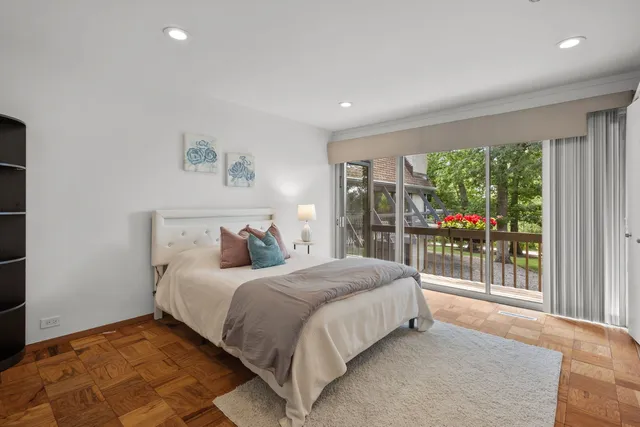 a bedroom with a large bed and a large window