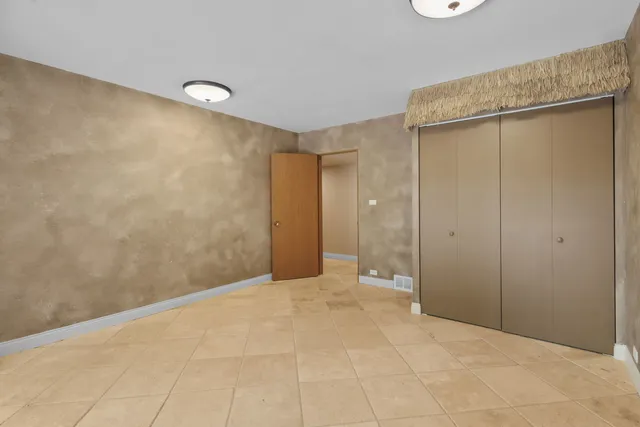 a living room with furniture and a view of kitchen