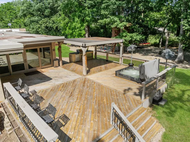 a view of a swimming pool and deck in the backyard