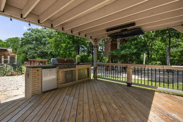 a view of back yard with green space and seating area