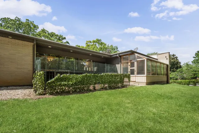 an aerial view of a house with a yard and outdoor space