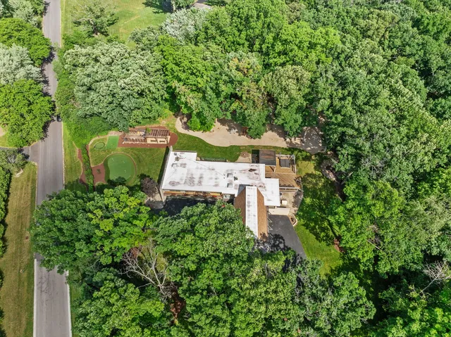 an aerial view of a house with yard