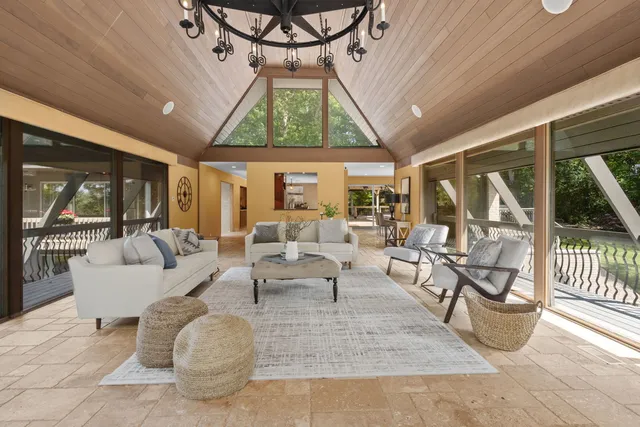 a living room with furniture and a chandelier
