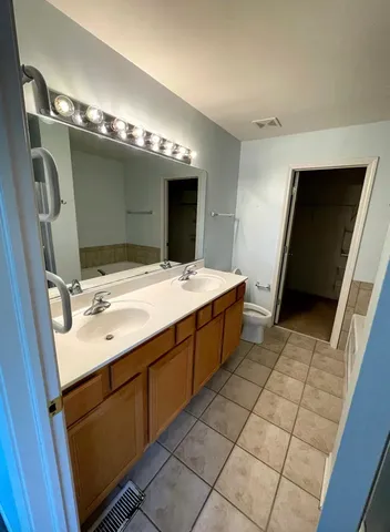 a bathroom with a sink double vanity and a mirror