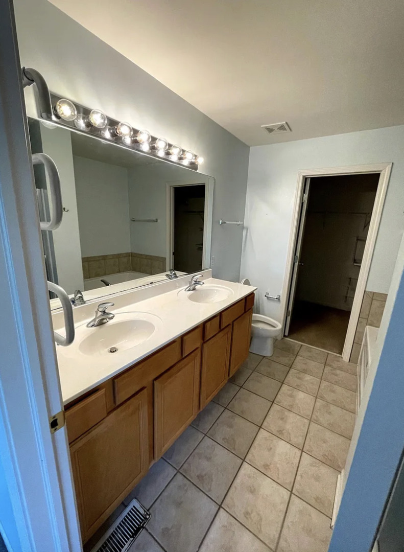 2326 Sunshine Lane Aurora, IL 60503 - Photo 14 of 27 a bathroom with a sink double vanity and a mirror
