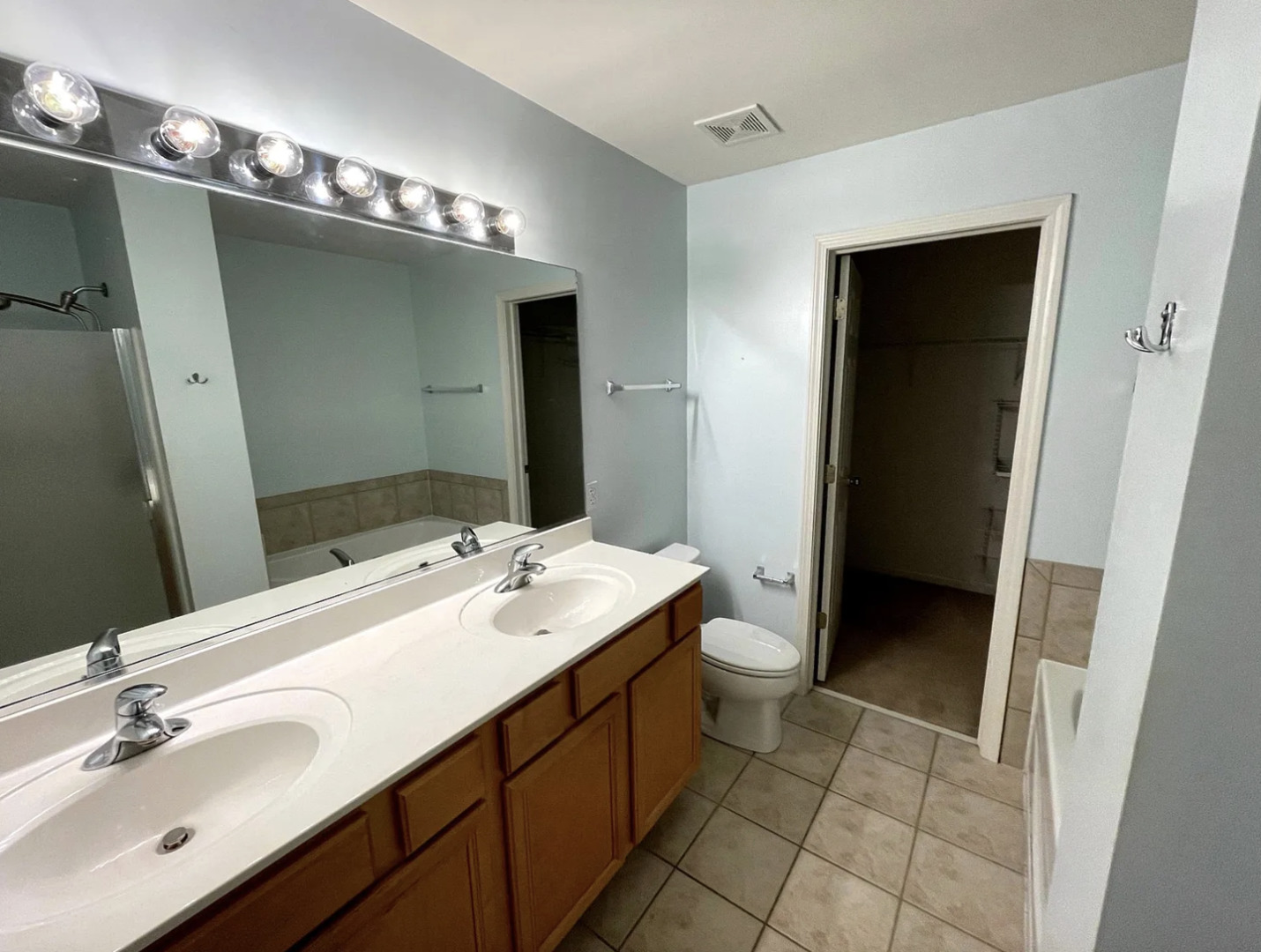 2326 Sunshine Lane Aurora, IL 60503 - Photo 15 of 27 a bathroom with a double vanity sink a and a mirror